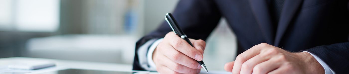 Close-up,Of,Male,Hands,With,Pen,Over,Document